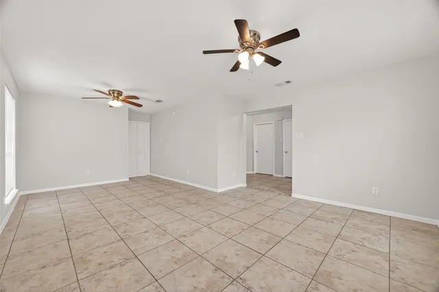 a view of a livingroom with a ceiling fan and window