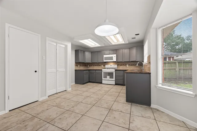 a open kitchen with cabinets and stainless steel appliances