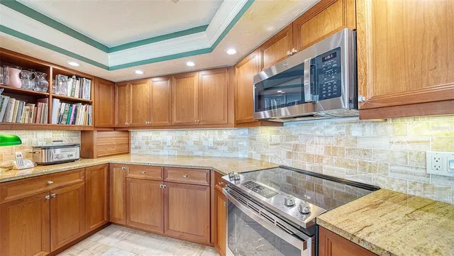 a kitchen with a stove sink and cabinets