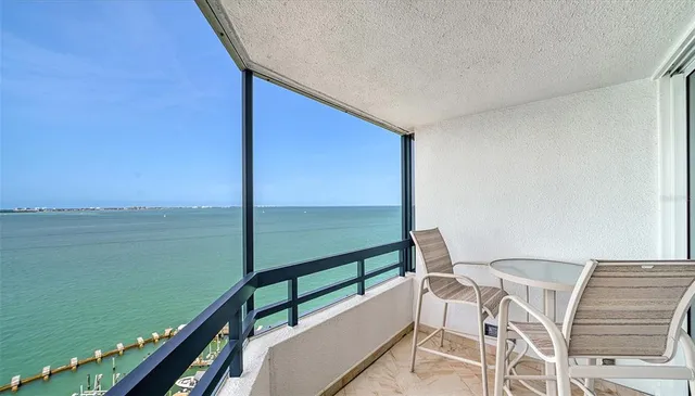 a living room with furniture a lamp and a large window