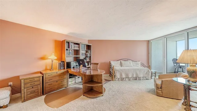 a view of a livingroom with furniture and bookshelf
