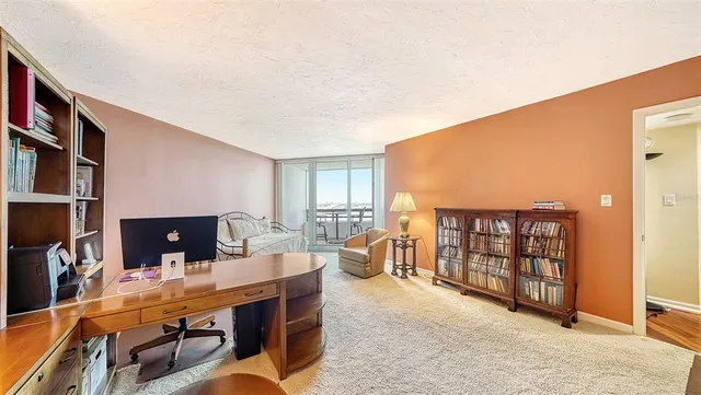 a bedroom with furniture and a large window