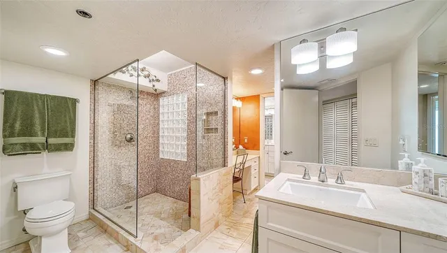 a spacious bathroom with a granite countertop sink and a mirror