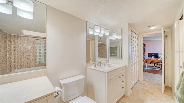 a bathroom with a shower toilet and sink