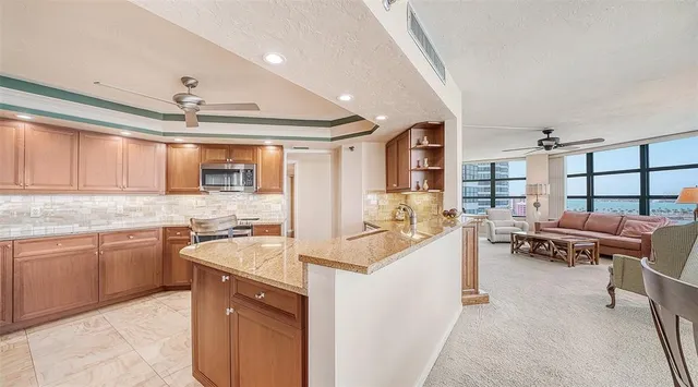 a kitchen with a table chairs stove and cabinets