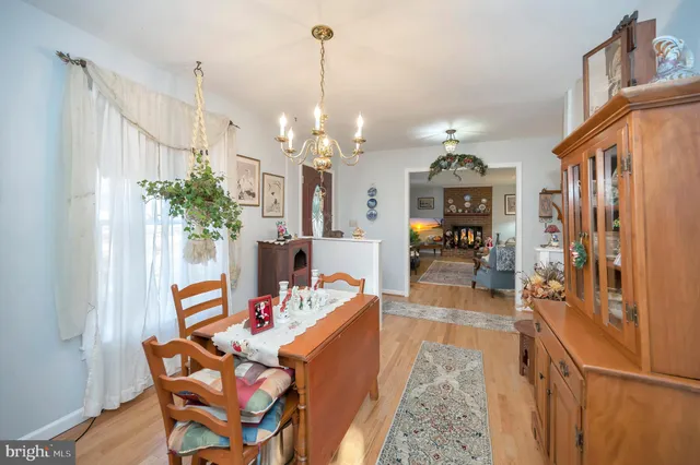 a dining room with furniture and a chandelier