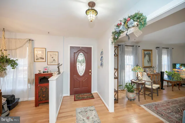 a living room with furniture a window and a chandelier