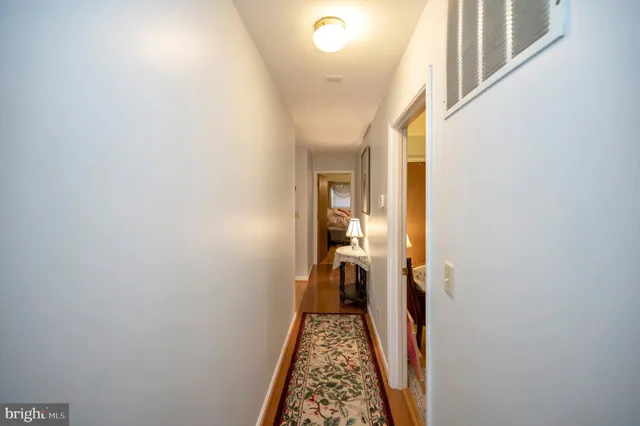 a view of hallway with wooden floor