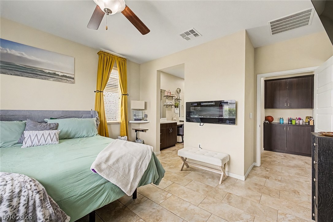 4914 East Beacon Ridge Drive Pahrump, NV 89061 - Photo 18 of 34 Relax in this tranquil sleeping area, complete with easy-care tile flooring and a view to the ensuite bathroom.
