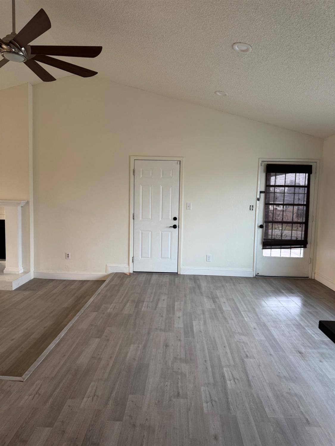 17269 Mark Road Madera, CA 93636 - Photo 14 of 23 a view of an empty room with a window and wooden floor