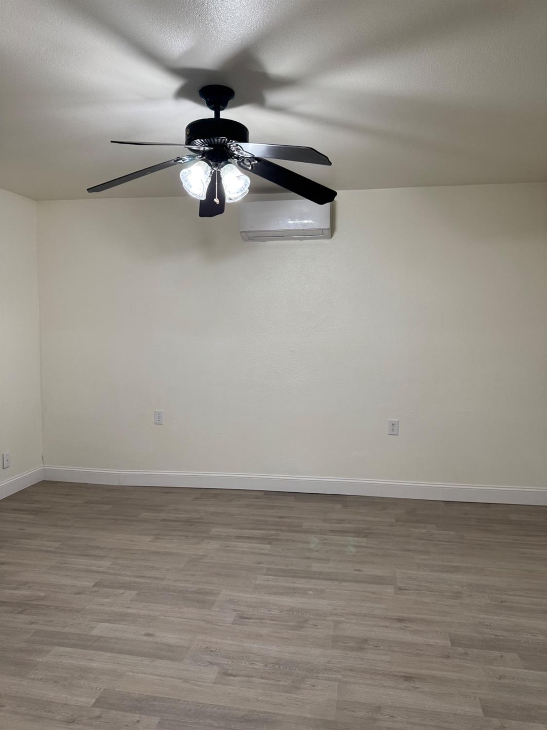 17269 Mark Road Madera, CA 93636 - Photo 16 of 23 a view of a room with wooden floor and white walls