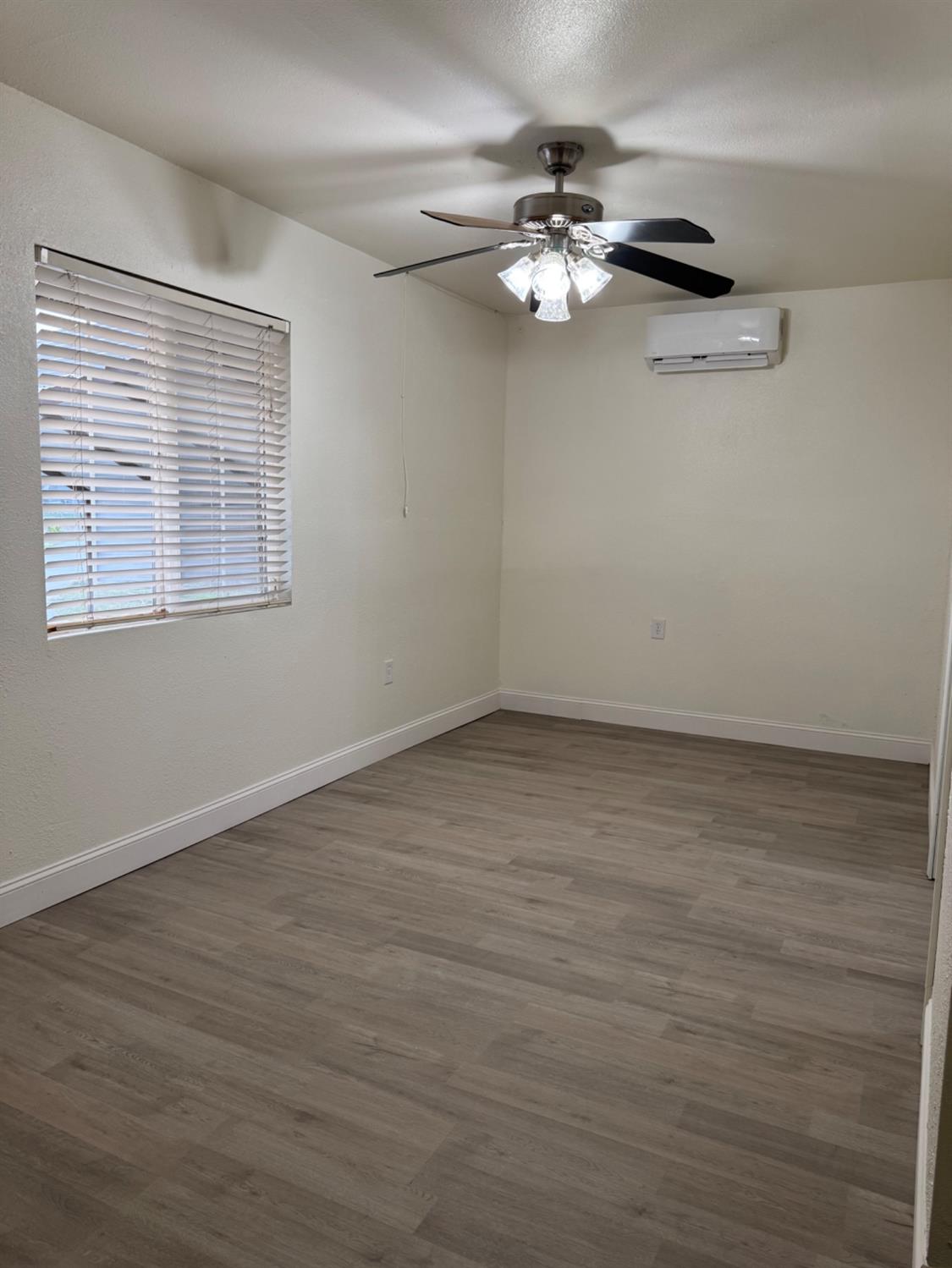 17269 Mark Road Madera, CA 93636 - Photo 18 of 23 wooden floor in an empty room with a window