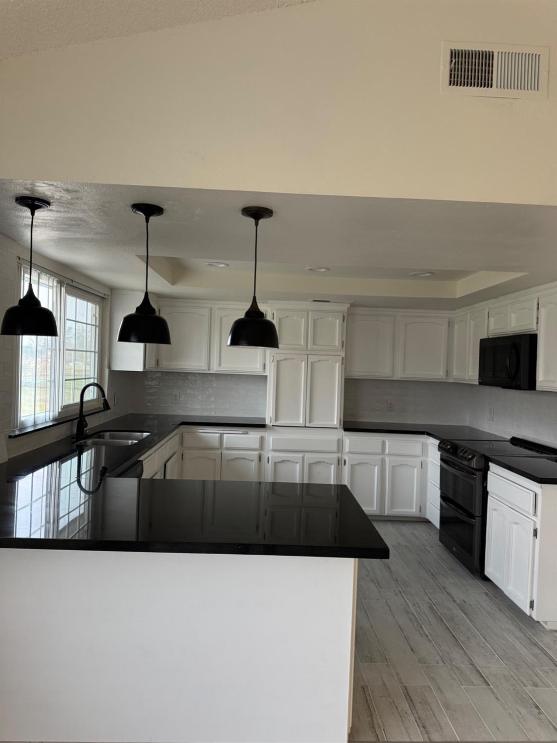 17269 Mark Road Madera, CA 93636 - Photo 5 of 23 a kitchen with stainless steel appliances kitchen island a stove a sink and a refrigerator