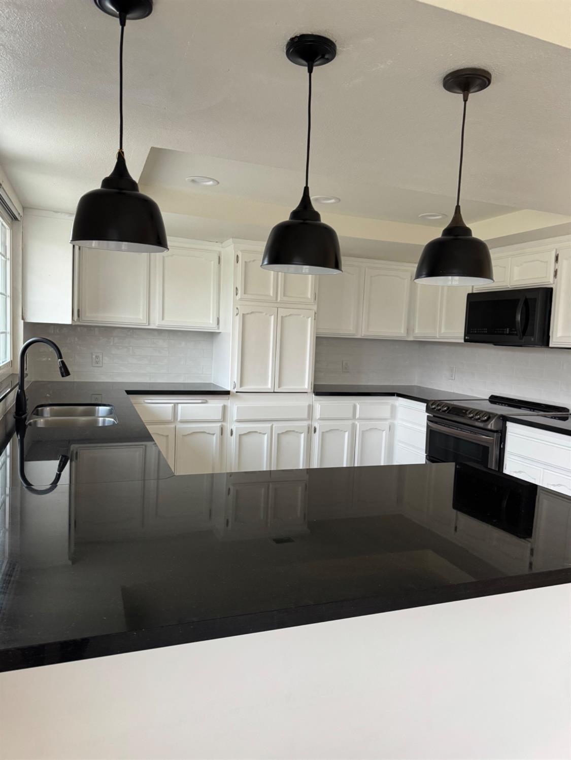 17269 Mark Road Madera, CA 93636 - Photo 6 of 23 a kitchen with a sink