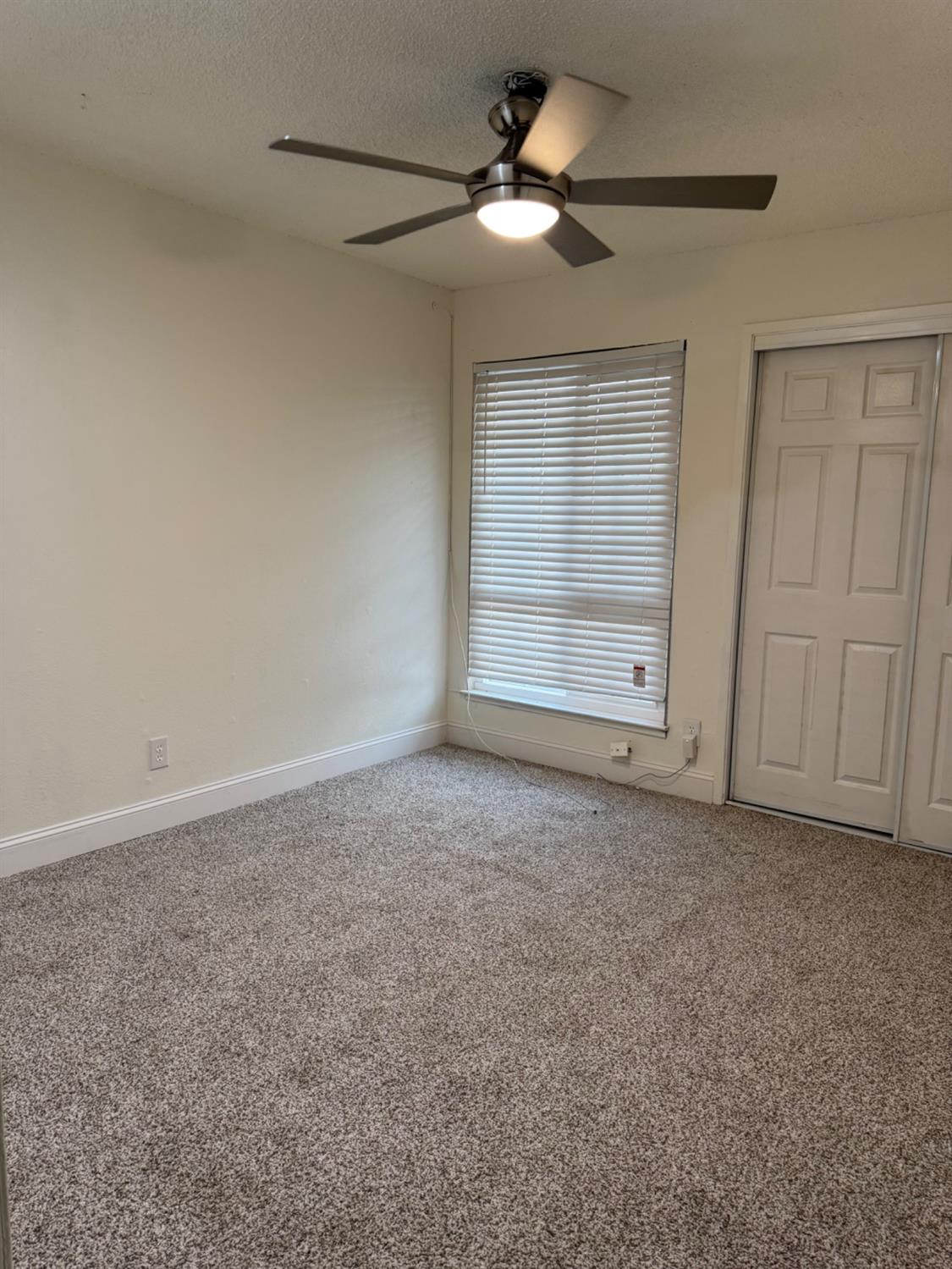 17269 Mark Road Madera, CA 93636 - Photo 9 of 23 an empty room with a empty space and a ceiling fan