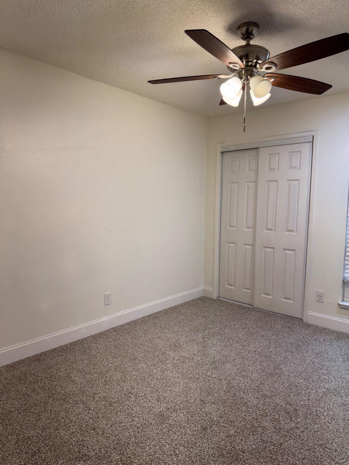 17269 Mark Road Madera, CA 93636 - Photo 10 of 23 a view of an empty room with a fan