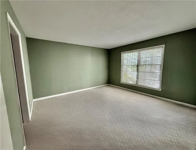an empty room with closet and mirror