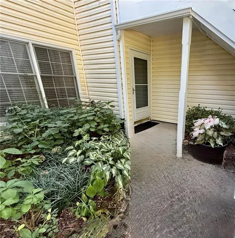 a view of a house with a window and a yard
