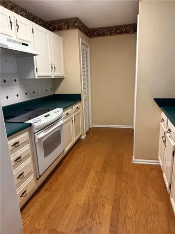 a kitchen with stainless steel appliances granite countertop a sink and a stove top oven