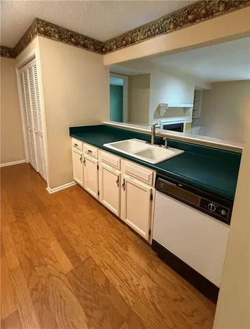 a kitchen with stainless steel appliances granite countertop a sink and a microwave