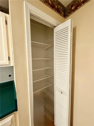 a view of a room with window and chandelier