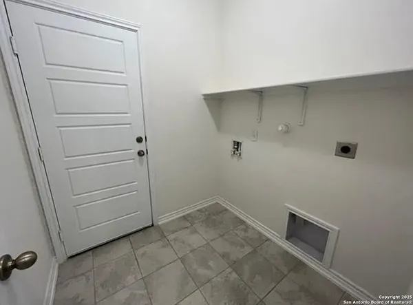 a view of a kitchen with refrigerator and cabinets