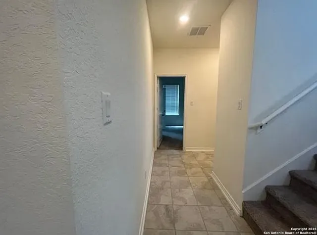 a view of hallway with closet and a white door