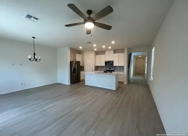 a view of a kitchen with a sink and a refrigerator
