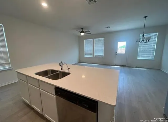 a kitchen with a sink a stove and cabinets