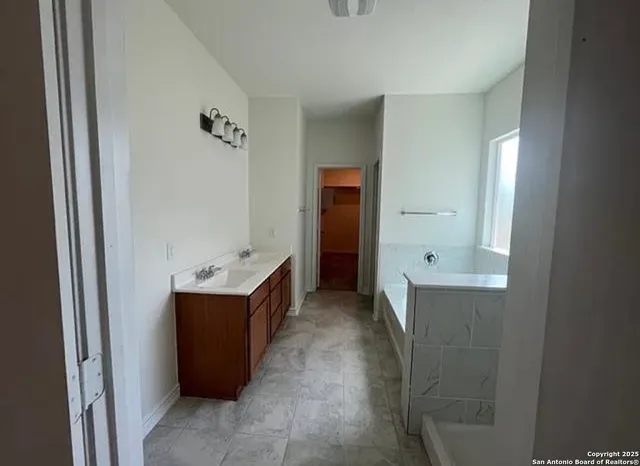 a bathroom with a bathtub and a sink