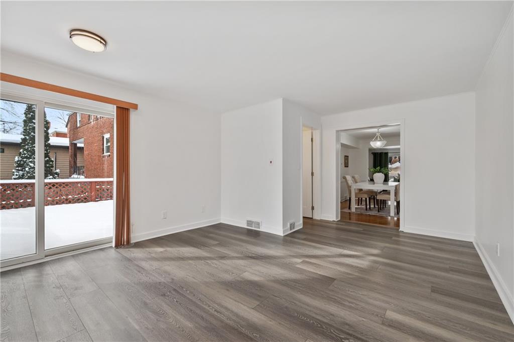 2923 Fernwald Road Pittsburgh, PA 15217 - Photo 12 of 36 a view of a livingroom with wooden floor and a ceiling fan