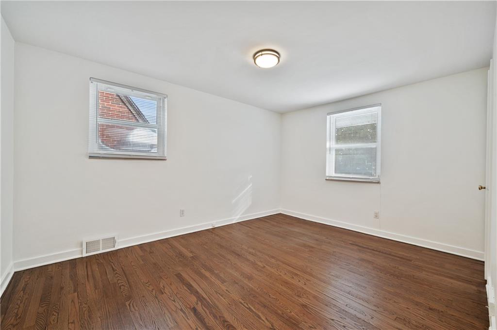 2923 Fernwald Road Pittsburgh, PA 15217 - Photo 21 of 36 an empty room with wooden floor and windows