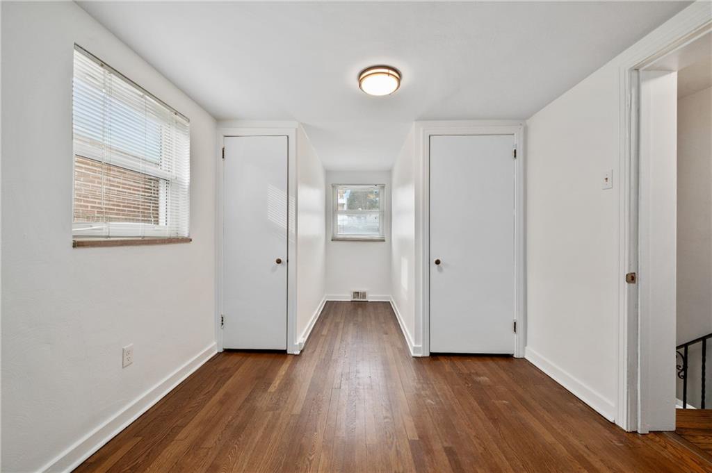 2923 Fernwald Road Pittsburgh, PA 15217 - Photo 24 of 36 a view of an empty room with wooden floor and a window