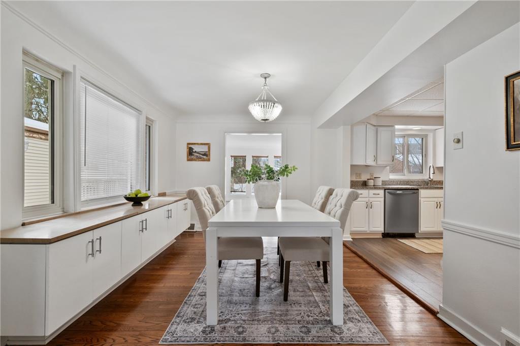 2923 Fernwald Road Pittsburgh, PA 15217 - Photo 5 of 36 a large white kitchen with granite countertop a stove a sink a dining table and chairs