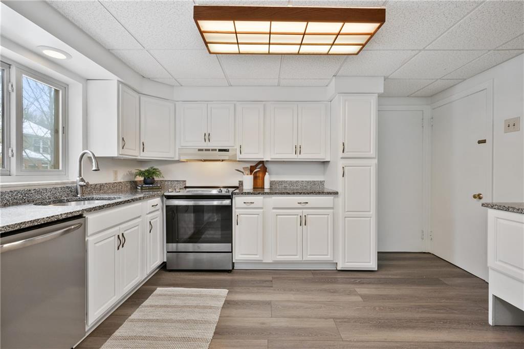 2923 Fernwald Road Pittsburgh, PA 15217 - Photo 7 of 36 a kitchen with stainless steel appliances granite countertop a stove and white cabinets