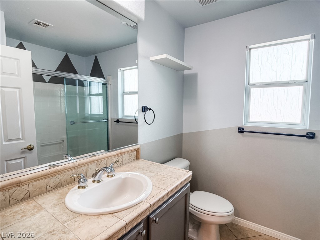 8683 Moreno Mountain Avenue Las Vegas, NV 89178 - Photo 16 of 26 A well-appointed bathroom with a spacious vanity, sleek shower, and ample natural illumination.