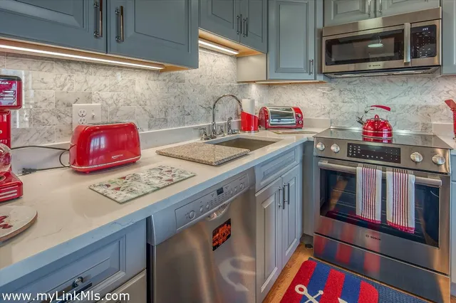 a kitchen with stainless steel appliances granite countertop a stove a microwave and cabinets