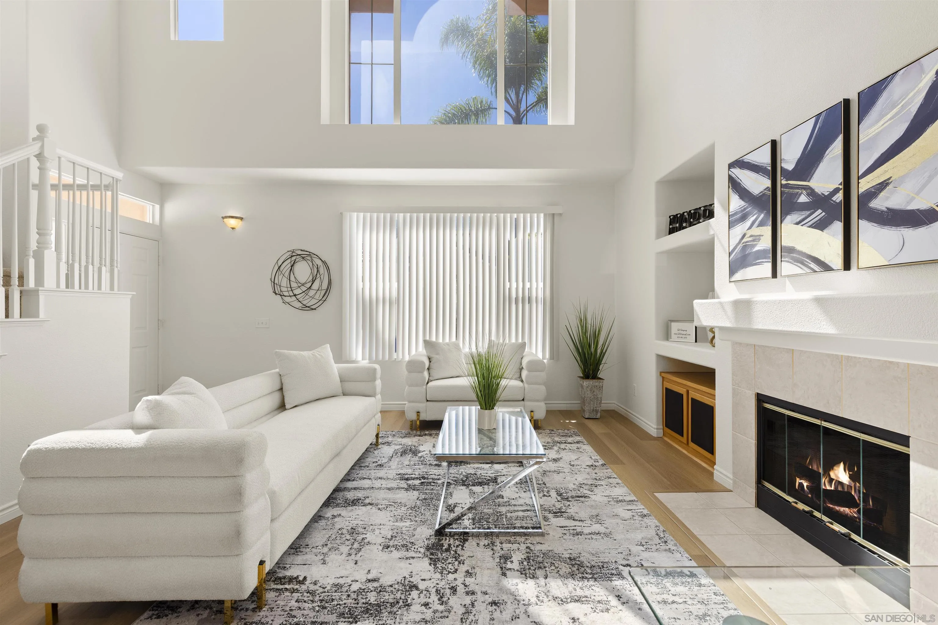 a living room with furniture a fireplace and a large mirror