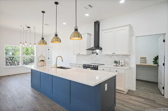 a kitchen with a sink a stove and a microwave