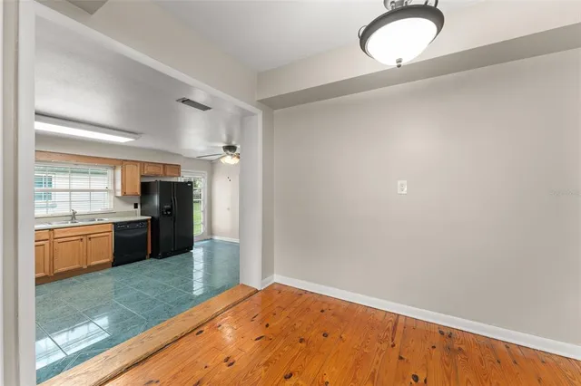 a kitchen with granite countertop a refrigerator and stove