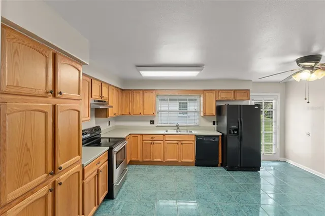 a kitchen with stainless steel appliances granite countertop a refrigerator and a sink