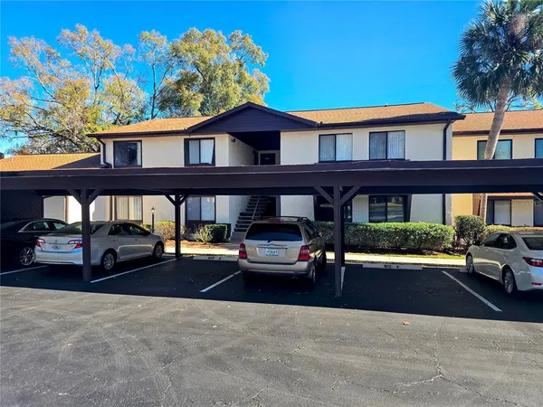 a front view of a residential apartment building with a yard