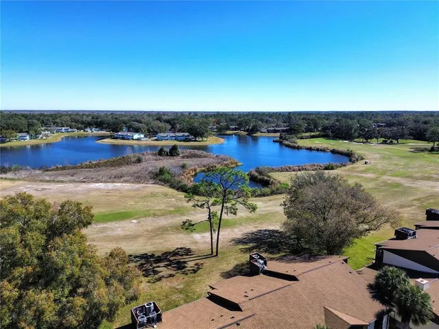 a view of a lake with a house in the background