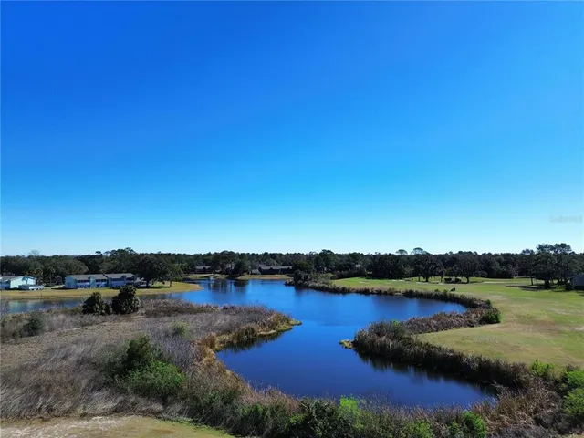 a view of a lake with houses in the back