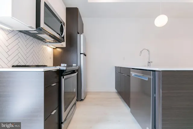 a kitchen with a refrigerator and a sink