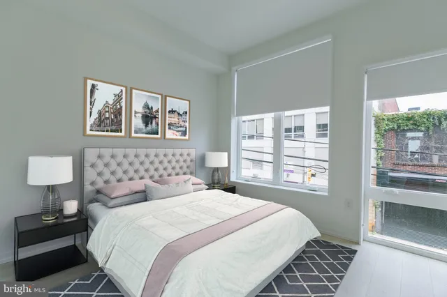 a bedroom with a large bed and a window