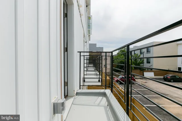 a view of a balcony with a floor to ceiling window with a barbeque