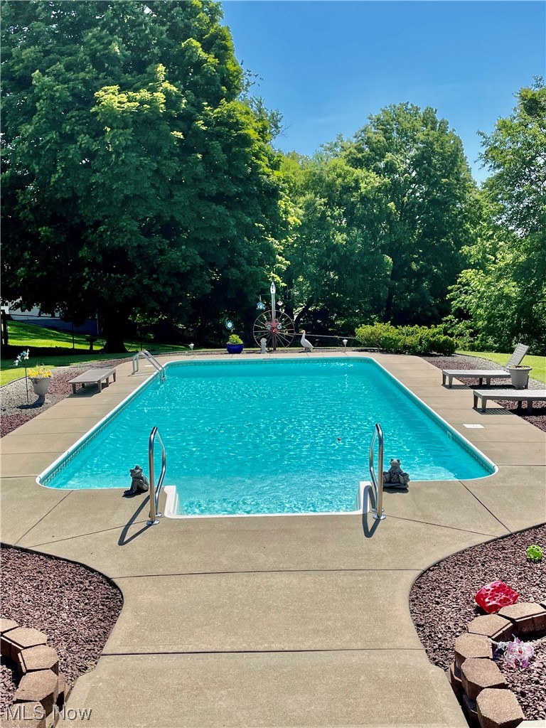 View of swimming pool with a patio area