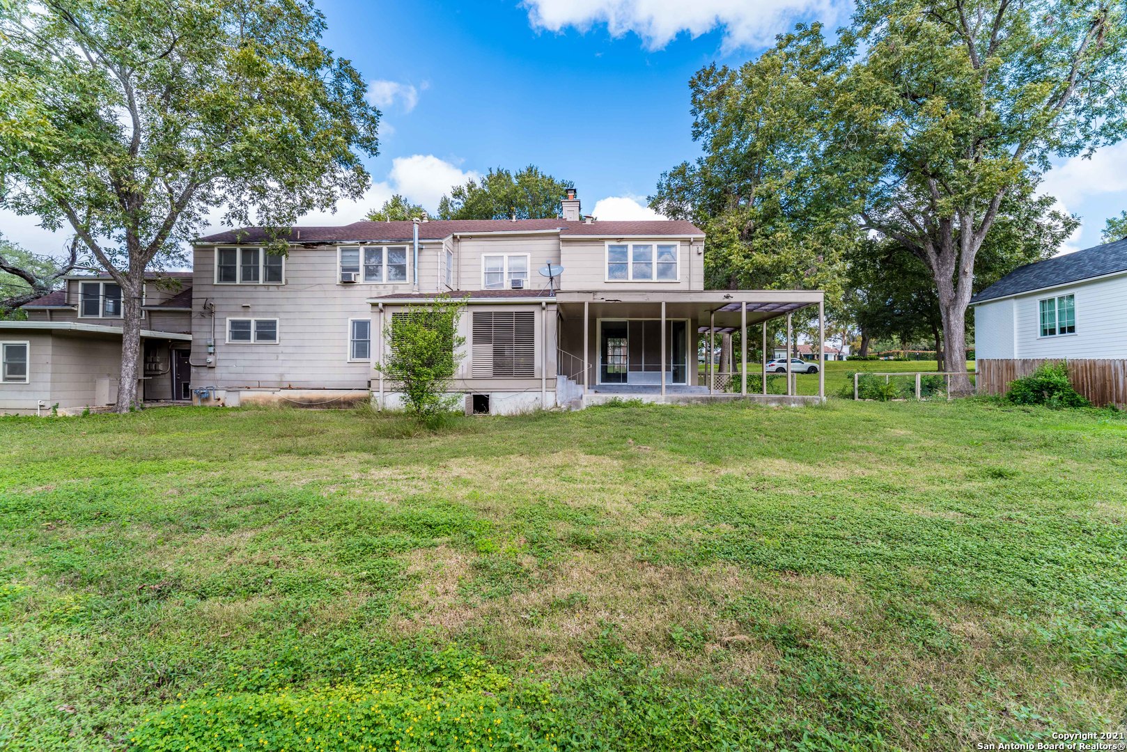 a front view of house with yard and green space