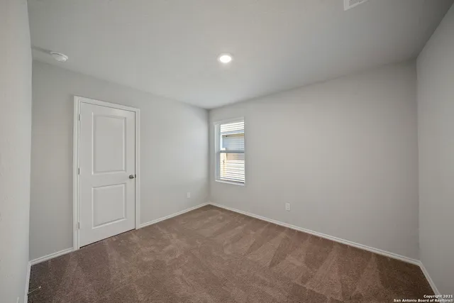 a view of an empty room and a window